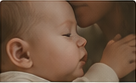 A parent holding a sleeping baby cheek to cheek.